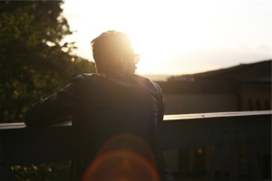 Person looks toward the sun and uses enhance coaching to look to the future and improve performance and self development